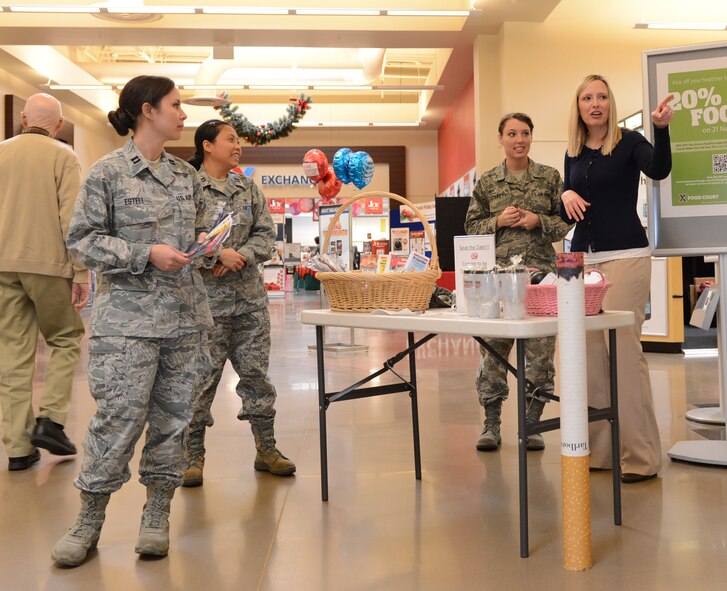 [Left to right] Capt. Jennilyn Estell, 20th Aerospace Medicine Squadron dental clinic advanced general dentist, Capt. Phuong Nguyen, 20th AMDS dental clinic general dentist, Staff Sgt. Tonya Collett, 20th AMDS dental clinic active duty dental referral NCO in charge, and Penny Hardin, 20th Aerospace Medicine Squadron Health Promotion flight program coordinator, pass out brochures to promote a healthy lifestyle at the Great American Smokeout table at Shaw Air Force Base, S.C., Nov. 21, 2013. The four distributed information to patrons at the Exchange on the day that the American Cancer Society urges people to quit smoking. (U.S. Air Force photo by Airman 1st Class Diana M. Giannetti/Released)