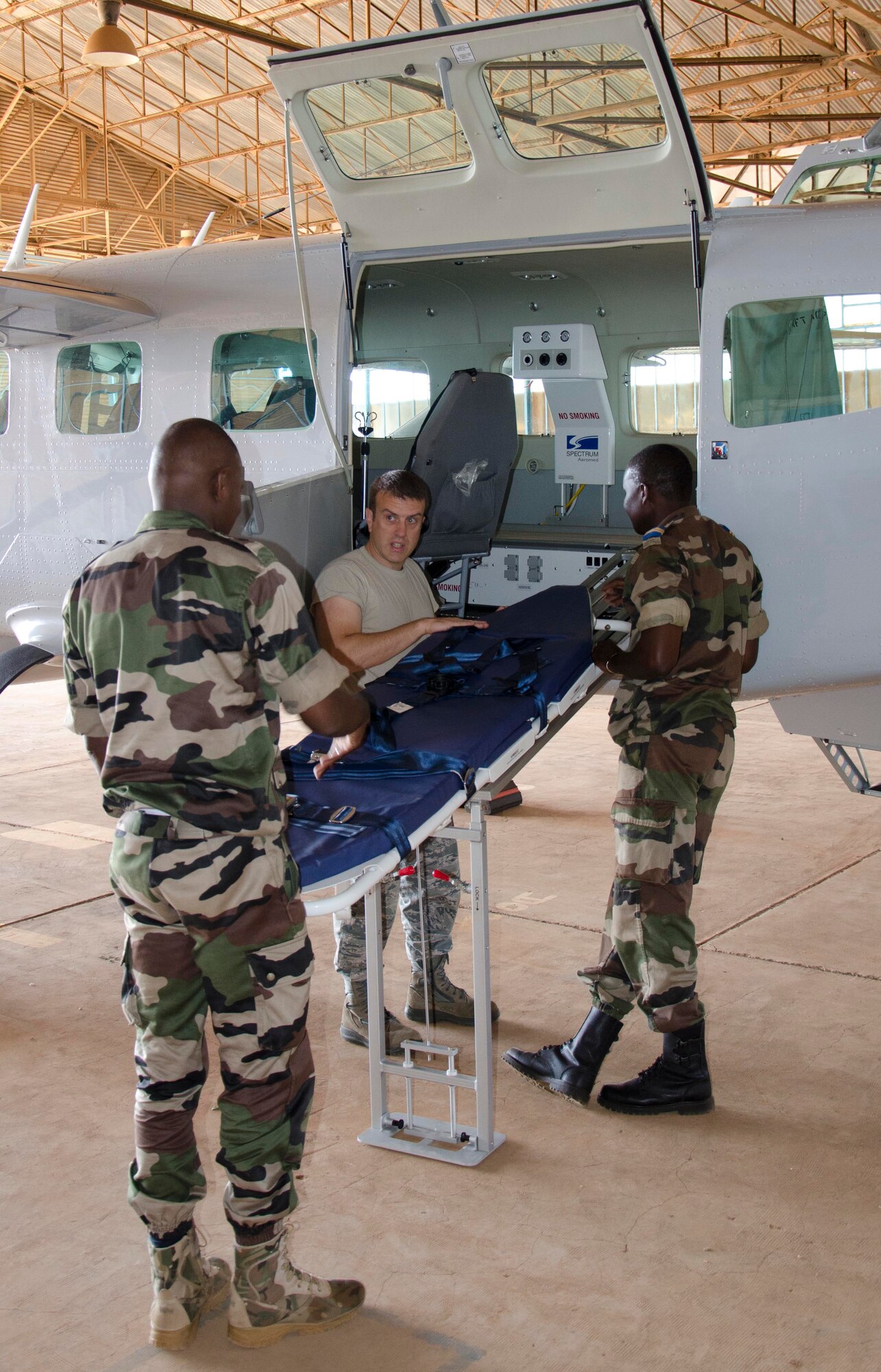 NIAMEY, Republic of Niger -- Maj. Michael Morrow, 818th Mobility Support Advisory Squadron air advisor, conducts aeromedical evacuation training with Niger National Flight Airmen at Airbase 101, Niamey, Niger, Nov. 7, 2013. The 818 MSAS sent a seven Airmen logistics management assistance team to provide a complete air mobility/logistics expertise package that was tailored to fit the needs of the partner nation, with a focus on hands-on training. (U.S. Air Force photo by Maj. Sean Hook)