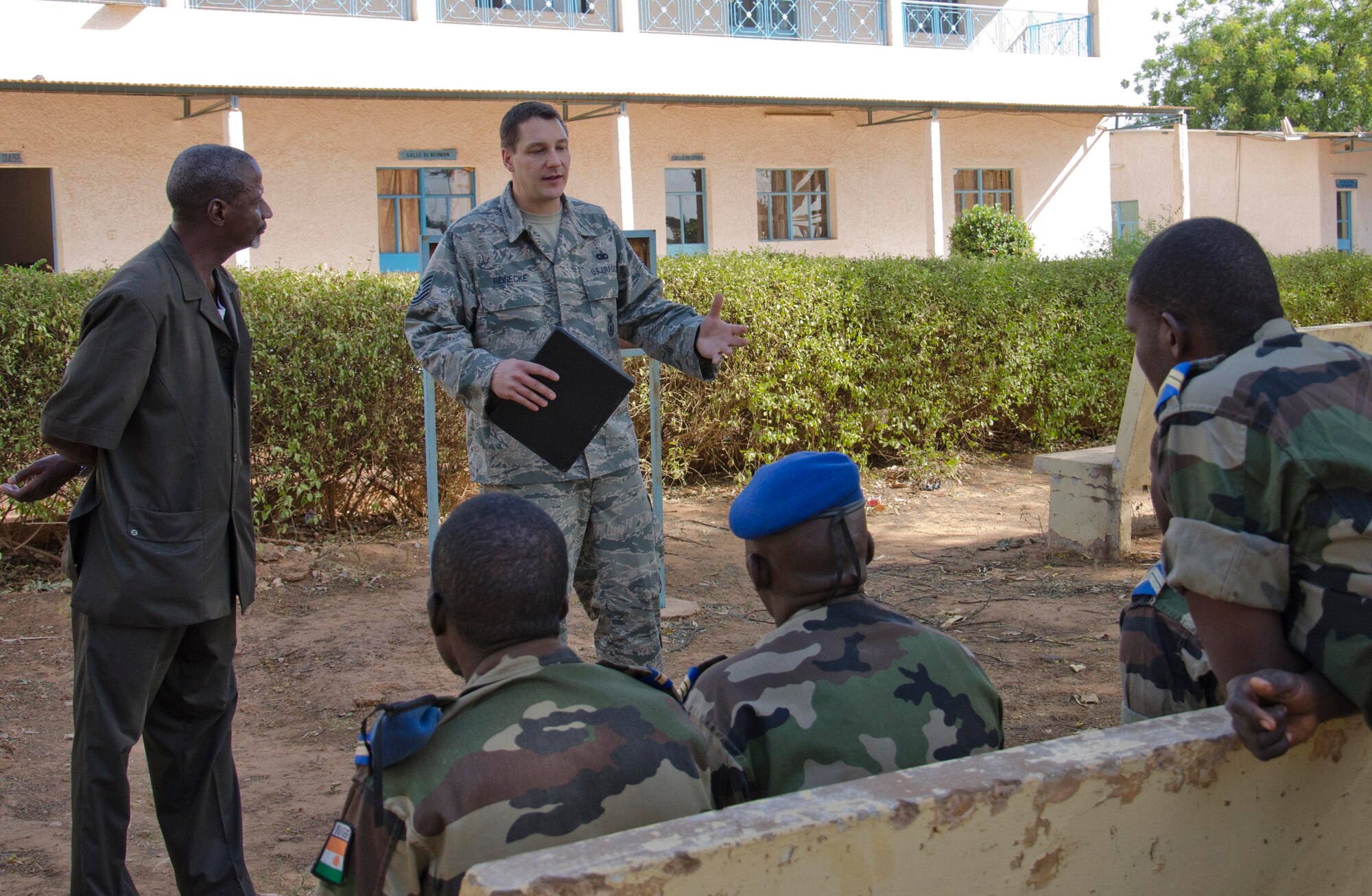 NIAMEY, Republic of Niger -- Tech. Sgt. Mark Reinecke, 818th Mobility Support Advisory Squadron air advisor, trains members of the Niger National Flight at Airbase 101, Niamey, Niger, Nov. 6, 2013. The engagement consisted of training the NAF in air drop operations, aircraft maintenance, aircrew survival, intelligence operations, aeromedical evacuation, field casualty care, and air base defense and entry control procedures. (U.S. Air Force photo by Maj. Sean Hook)