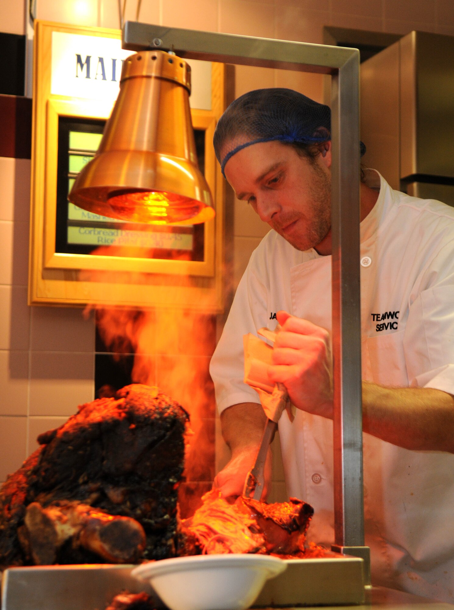 Jamie Davis, 100th Force Support Squadron cook at the Gateway Dining Facility, carves roast beef during the Thanksgiving lunch served in celebration of the American holiday Nov. 22, 2012, on RAF Mildenhall, England. The cooks prepared lunch for around 350 members of Team Mildenhall for the meal. (U.S. Air Force photo by Tech. Sgt. Austin M. May/Released) (Editor’s note: Tech. Sgt. Austin M. May was the rank of Staff Sgt. when this photo was taken)