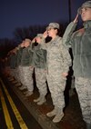 Members of the 100th Operations Group, 727th Air Mobility Squadron and 100th Air Refueling Wing Staff Agencies salute the U.S. flag as it’s lowered during the monthly retreat ceremony Nov. 22, 2013, on RAF Mildenhall, England. Retreat is a long-standing tradition honoring the flag and signaling the end of the duty day. A retreat ceremony, in which the U.S. flag and Royal Air Force ensign are retired, takes place the last Friday of every month. (U.S. Air Force photo by Airman 1st Class Preston Webb/Released)