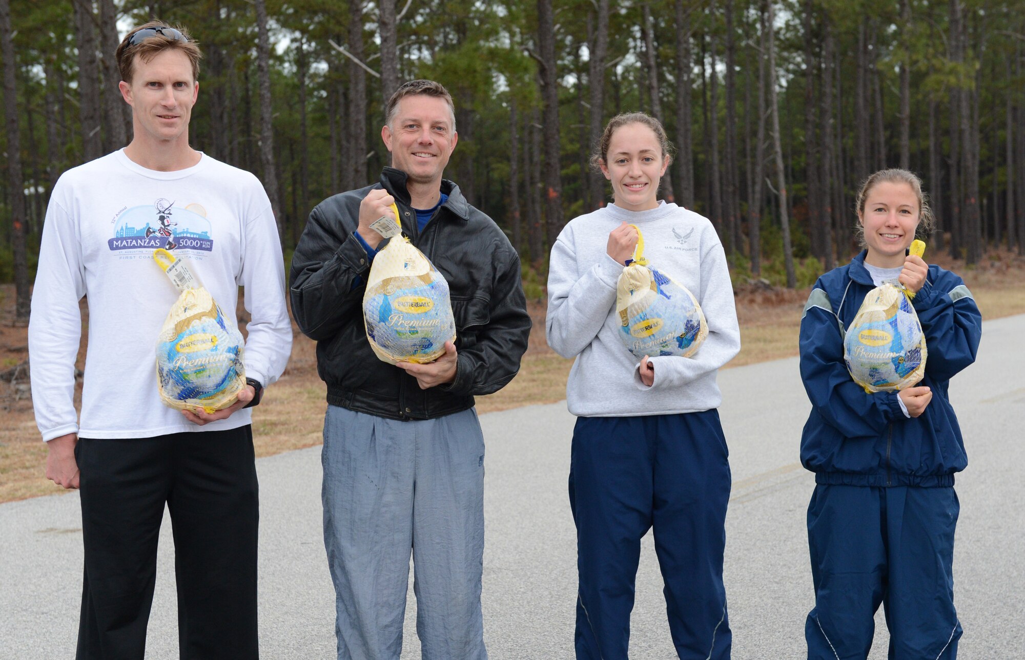 [Left to right] Master Sgt. John Delaney, Lt. Col. Ryan Krietsch, 2nd Lt. Micah Wessinger, and Senior Airman Meryl King, pose for a winner’s photo after the Turkey Trot and Great American Smokeout 5K at Shaw Air Force Base, S.C., Nov. 15, 2013. The four competed in the race, earning first and second places in the male and female division and earning a 10-pound turkey. (U.S. Air Force photo by Airman 1st Class Diana M. Giannetti/Released)