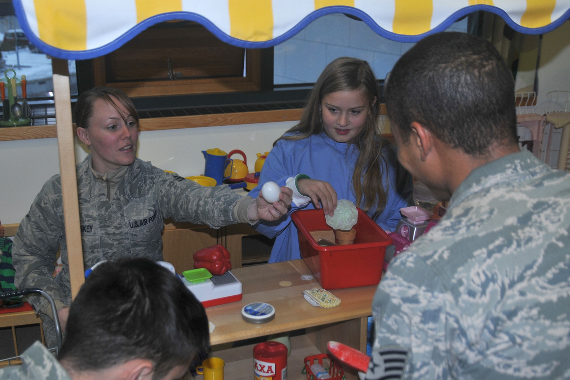 Staff Sgt. Tina McCloskey, 48th Air Expeditionary Group NCO in charge of services, plays with Katla Örk Marteindóttir, a family member of a patient at University Hospital-Children’s Hospital in Reykjavik, Iceland, Nov. 18, 2013. More than 20 Airmen from the 48th AEG visited the University Hospital-Children’s Hospital in Reykjavik, Iceland; the Airmen brought candy and toys along with them to give to the children. The 48th AEG is deployed to Iceland in support of air policing and surveillance missions throughout the month of November. (U.S. Air Force photo by 1st Lt. Leah Davis/Released)