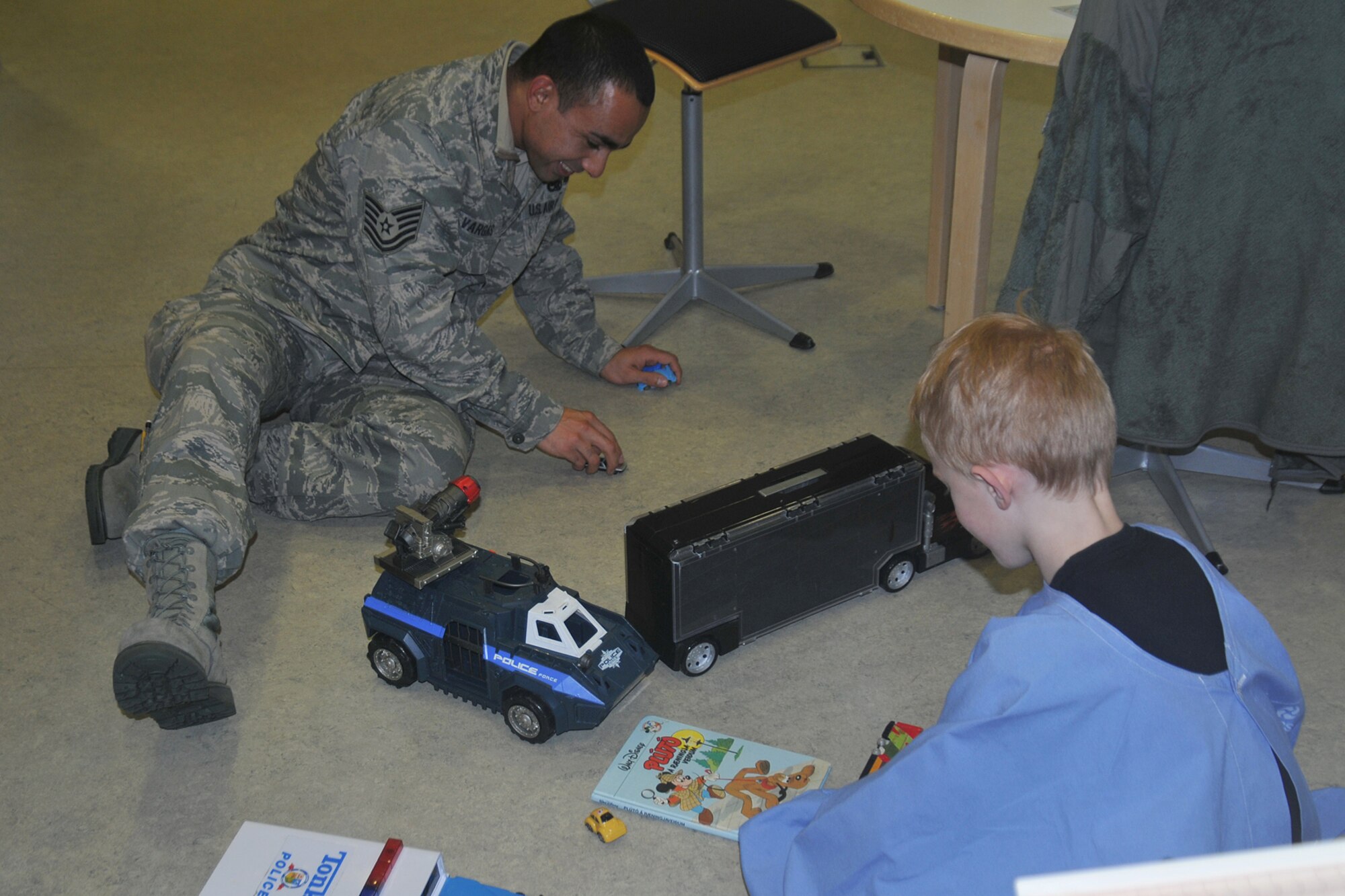 Tech. Sgt. Jorge Vargas, 493rd Expeditionary Fighter Squadron NCO in charge of nondestructive inspection lab, plays with Sigurdur Rikhardt Marteinsson, a family member of a patient at University Hospital-Children’s Hospital in Reykjavik, Iceland, Nov. 18, 2013. More than 20 Airmen from the 48th AEG visited the University Hospital-Children’s Hospital in Reykjavik, Iceland; the Airmen brought candy and toys along with them to give to the children. The 48th AEG is deployed to Iceland in support of air policing and surveillance missions throughout the month of November. (U.S. Air Force photo by 1st Lt. Leah Davis/Released)