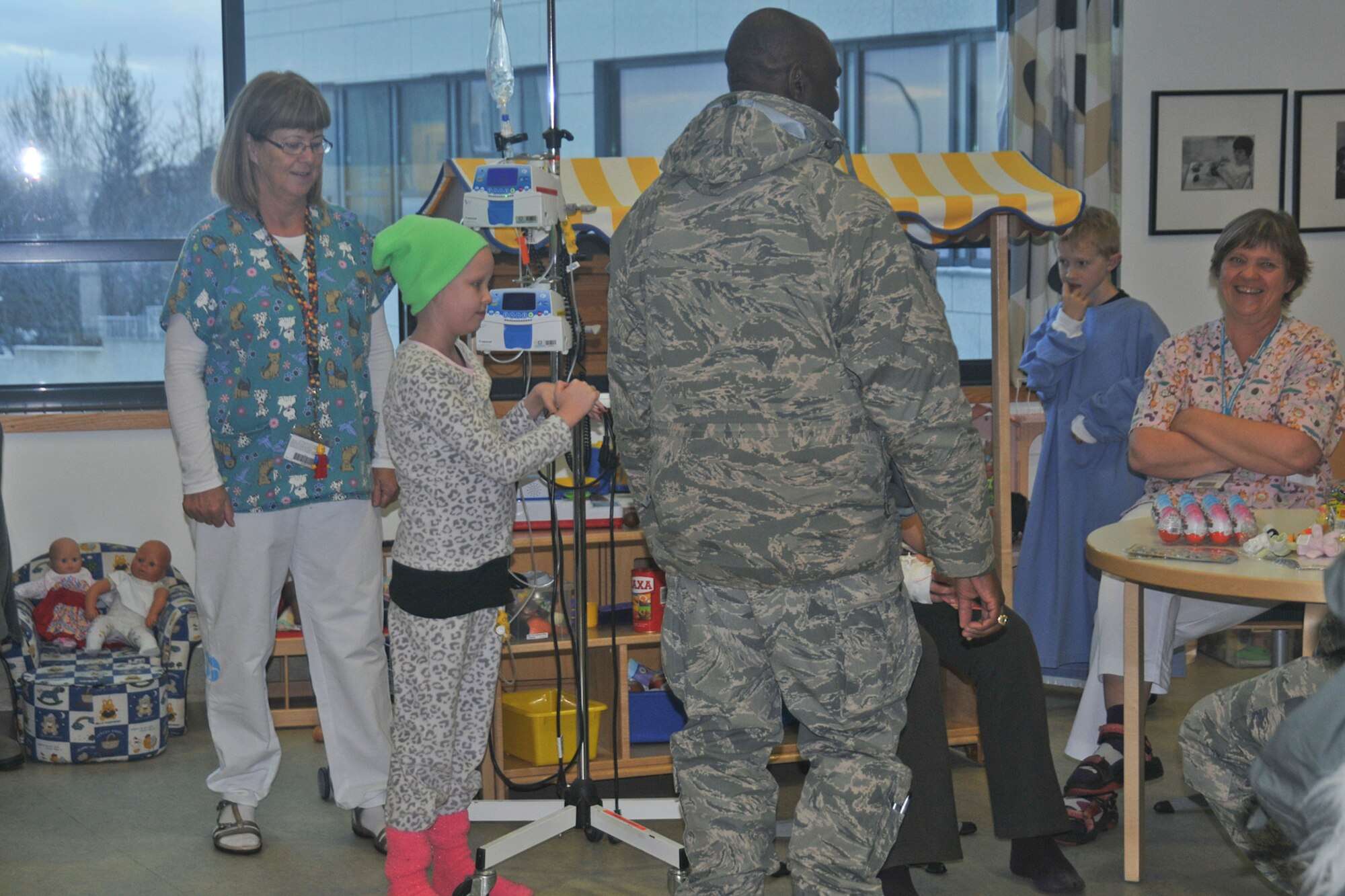 Chaplain (Capt.) Sean Ballard, 48th Air Expeditionary Group chaplain, speaks with nurses and Sigurdis Björgvinsdóttir, a patient at University Hospital-Children’s Hospital in Reykjavik, Iceland, Nov. 18, 2013. More than 20 Airmen from the 48th AEG visited the University Hospital-Children’s Hospital in Reykjavik, Iceland; the Airmen brought candy and toys along with them to give to the children. The 48th AEG is deployed to Iceland in support of air policing and surveillance missions throughout the month of November. (U.S. Air Force photo by 1st Lt. Leah Davis/Released)