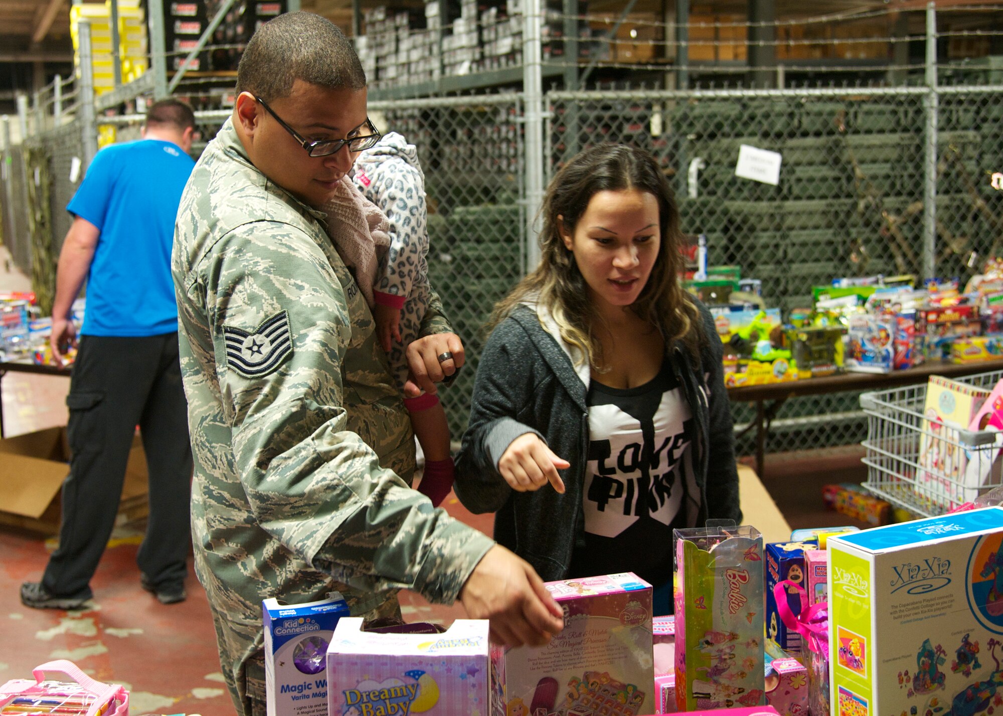 Tech Sgt. Urayoan Rodriguez, of the 33rd Maintenance Squadron, picks out toys for his children alongside his wife, Jenny, at the 10th annual toy drive hosted by the Airman’s Attic at Eglin Air Force Base, Fla., Nov. 22. More than 11,000 toys were donated for the drive, helping more than 300 families in the Eglin community. (U.S. Air Force photo/Sara Vidoni)