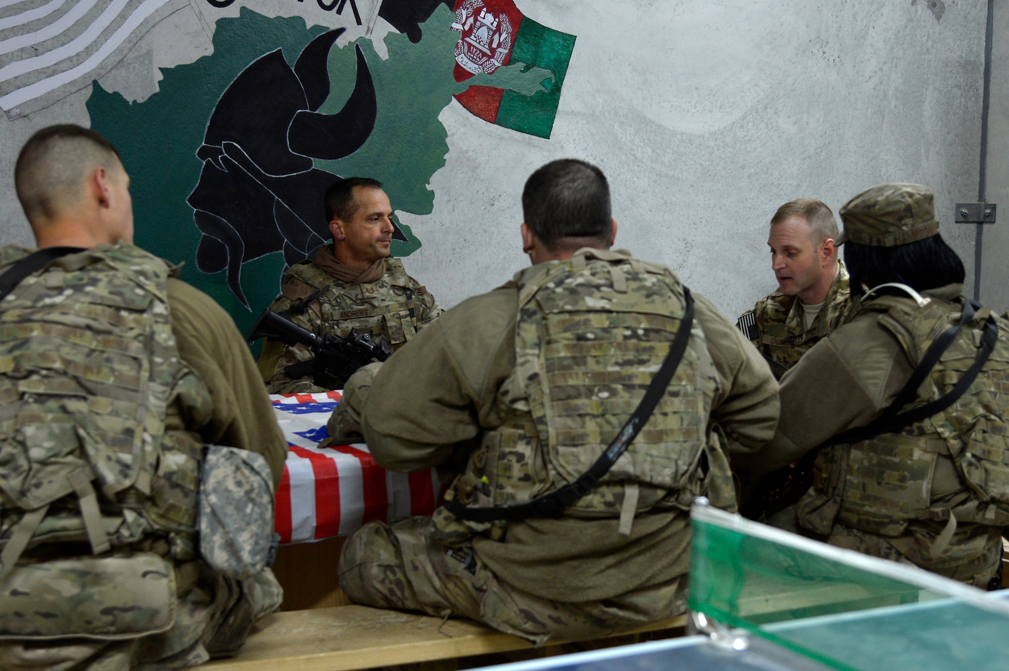 U.S. Air Force Chaplain (Capt.) Robert Chandler, 455th Air Expeditionary Wing, reads a scripture to members of the 455th Expeditionary Base Defense Squadron at Bagram Airfield, Afghanistan, Nov. 24, 2013. Chandler visited with the Airmen during guard mount. Chandler and Rivas are a religious support team assigned to the 455th EBDS. Chandler is deployed from Offutt Air Force Base, Neb. and hails from Greenville, S.C. (U.S. Air Force photo by Senior Airman Kayla Newman/Released)
