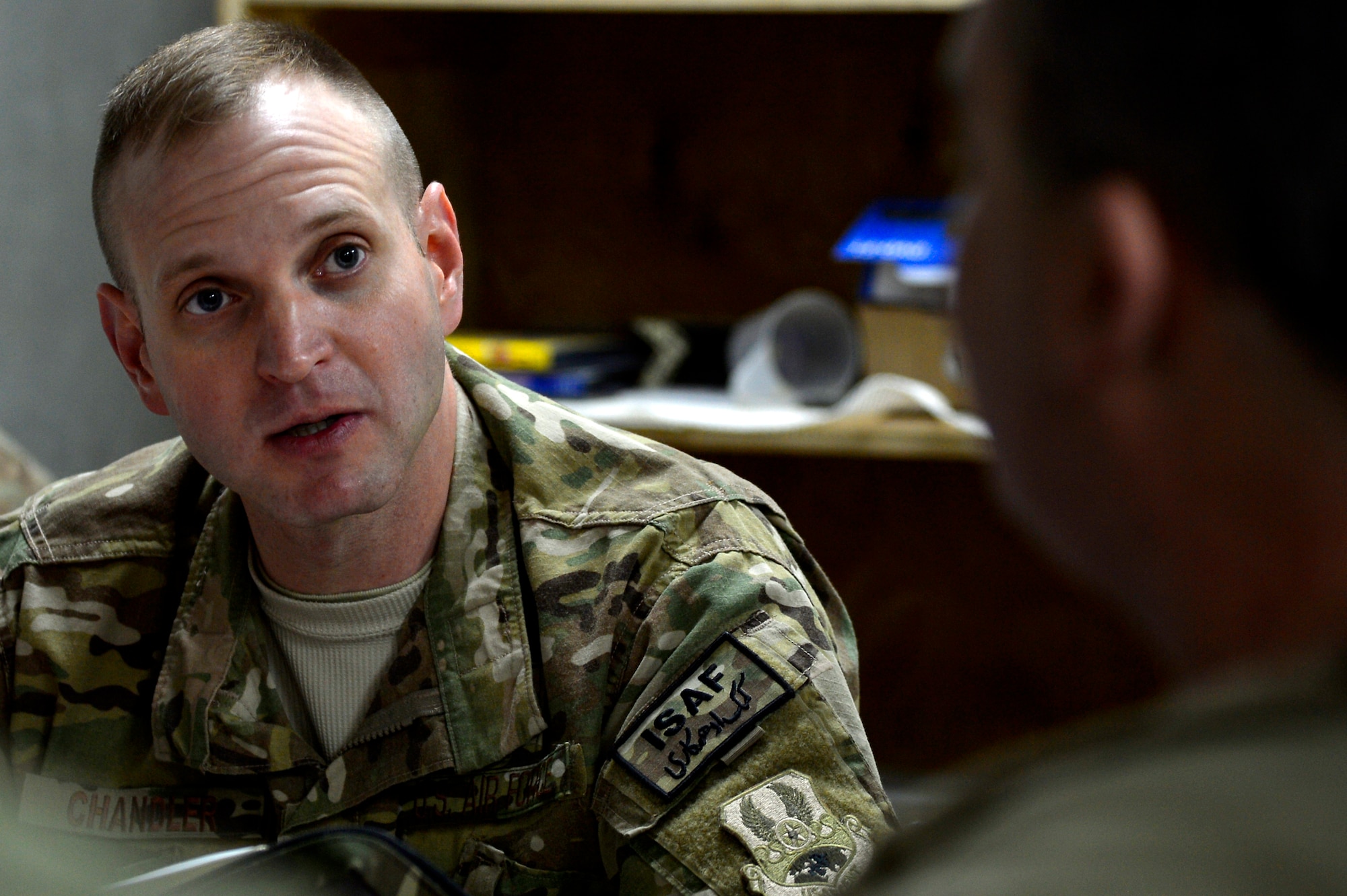 U.S. Air Force Chaplain (Capt.) Robert Chandler, 455th Air Expeditionary Wing, reads a scripture to members of the 455th Expeditionary Base Defense Squadron at Bagram Airfield, Afghanistan, Nov. 24, 2013. Chandler visited with the Airmen during guard mount. Chandler and Rivas are a religious support team assigned to the 455th EBDS. Chandler is deployed from Offutt Air Force Base, Neb. and hails from Greenville, S.C. (U.S. Air Force photo by Senior Airman Kayla Newman/Released)