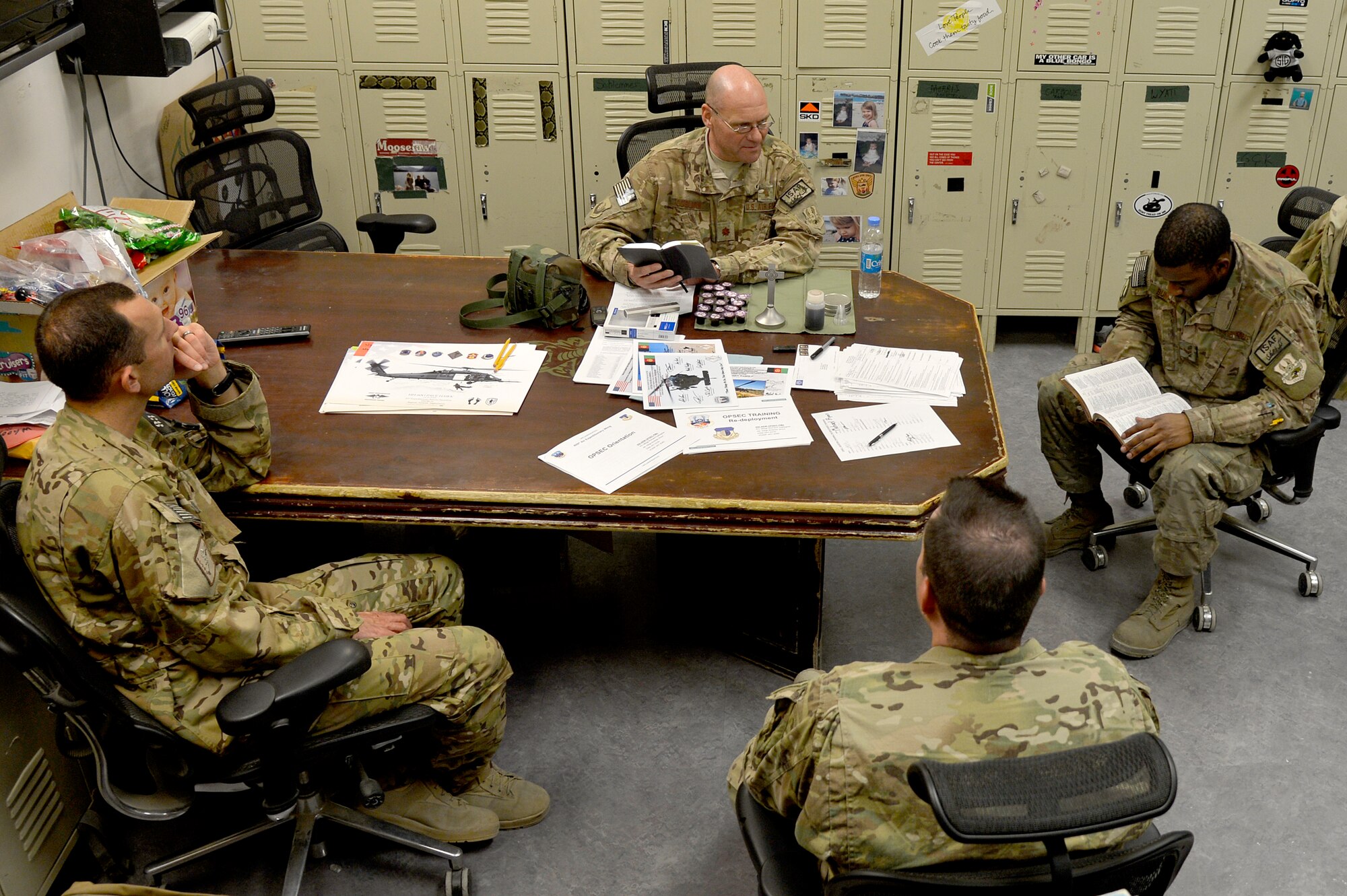 U.S. Air Force Chaplain (Maj.) Gary Coburn, 455th Air Expeditionary wing, visits the 83rd Expeditionary Rescue Squadron at Bagram Airfield, Afghanistan, Nov. 24, 2013. Coburn held a small service for Airmen assigned to the 83rd ERQS in their briefing room. Coburn is deployed from Buckley Air Force Base, Colo. (U.S. Air Force photo by Senior Airman Kayla Newman/Released)