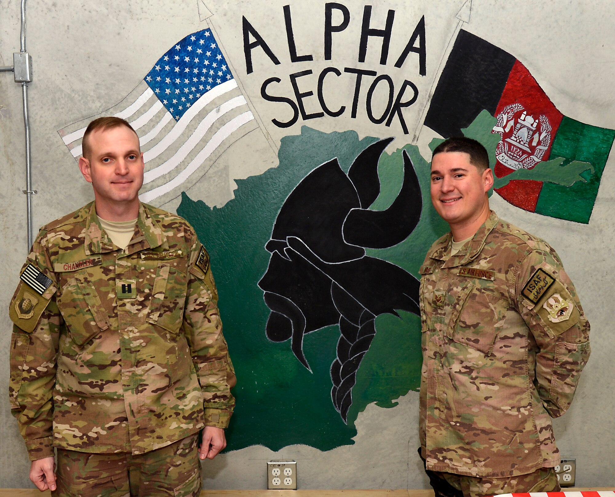 U.S. Air Force Chaplain (Capt.) Robert Chandler, 455th Air Expeditionary Wing, and Staff Sgt. Frank Rivas, 455th AEW chaplains assistant, pose for a picture before providing their services to the Airmen of the 455th Expeditionary Base Defense Squadron at Bagram Airfield, Afghanistan, Nov. 24, 2013. Chandler and Rivas are a religious support team assigned to the 455th EBDS. Chandler is deployed from Offutt Air Force Base, Neb., and Rivas from MacDill Air Force Base, Fla. (U.S. Air Force photo by Senior Airman Kayla Newman/Released)