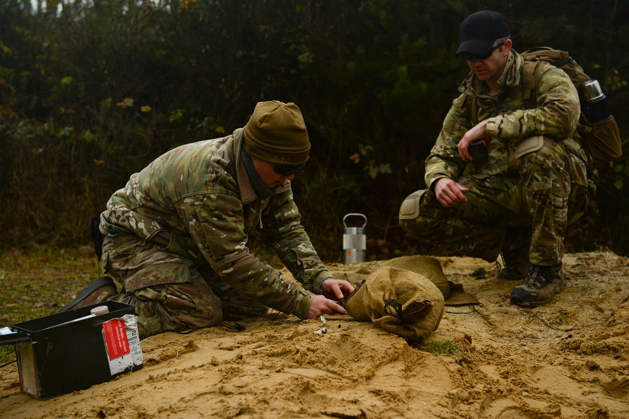 SPANGDAHLEM AIR BASE, Germany--Tech. Sgt. David Collins, 52nd Civil Engineer Squadron Explosive Ordnance Disposal Unit NCO in charge of plan and intelligence from Pine Columbus, Ga., teaches  Airman 1st Class Austin Hisel, a 52nd CES EOD apprentice, from Kankakee, Ill., how to setup a blasting cap during a pumpkin demo training session Nov. 6, 2013. Part of the reason the training was held was to help the new Airmen in the EOD flight with their upgrade training. (U.S. Air Force photo by Senior Airman Rusty Frank/Released)