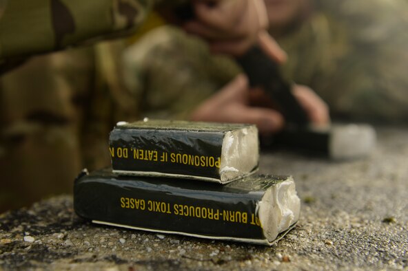 SPANGDAHLEM AIR BASE, Germany--Blocks of C-4 are cut to size during a pumpkin demo training session at the explosive ordnance disposal unit range DATE. During the training members of EOD used C-4, 50 caliber, and other explosives to detonate more than five pumpkins. (U.S. Air Force photo by Senior Airman Rusty Frank/Released)