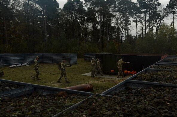 SPANGDAHLEM AIR BASE; Germany--Members of the 52nd Civil Engineer Squadron Explosive Ordnance Disposal Flight prepare to detonate a pumpkin during a pumpkin demo training session Nov. 6, 2013. Members of EOD put on the training annually after Halloween; this year they detonated more than five pumpkins. (U.S. Air Force photo by Senior Airman Rusty Frank/Released)