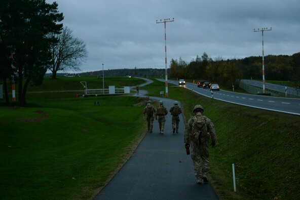 SPANGDAHLEM AIR BASE, Germany--Members from the 52nd Civil Engineer Squadron Explosive Ordnance Disposal Flight walk five miles in a ruck march to the EOD range for a pumpkin demo training session Nov. 6, 2013. During the training members of EOD rucked three and half miles to the range and then detonated more than five pumpkins. (U.S. Air Force photo by Senior Airman Rusty Frank/Released)