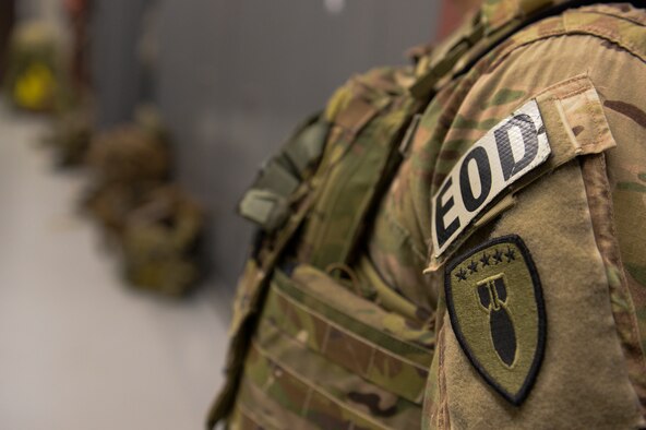 SPANGDAHLELM AIR BASE, Germany--Explosive ordnance disposal patches are displayed on the shoulder of a 52nd Civil Engineer Squadron EOD technician prior to a three mile ruck to the EOD range for a pumpkin demo training Nov. 6, 2013. The members of EOD held the pumpkin demo to fulfill annual training requirements and train new Airmen on core tasks. (U.S. Air Force photo by Senior Airman Rusty Frank/Released)