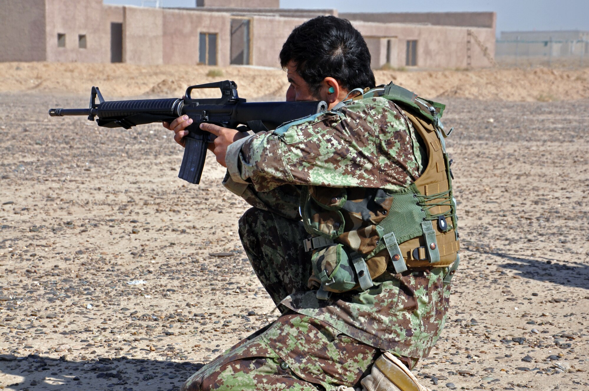 An Afghan Air Force security forces member takes position as part of a fire team after practicing an infiltration drill from a Mi-17 helicopter Nov. 10, 2013 near Kandahar Airfield, Afghanistan. Members of the Kandahar Air Wing Security Forces Kandak conducted fly away training with NATO Air Training Command-Afghanistan advisors from the 443rd and 441st Air Expeditionary Advisory Squadrons. The 18-person class was taught the basics of air assault, including infiltration and exfiltration, unloading and loading from an aircraft and how to secure an aircraft. (U.S. Air Force photo/Capt. Anastasia Wasem)
