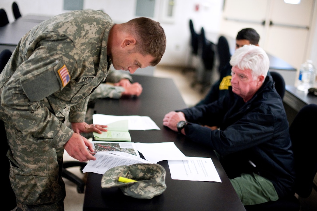 Army Staff Sgt. Seth Proft briefs team members during phase two of the Reconnaissance Surveillance Leaders Course on Fort Benning, Ga., Nov. 13, 2013.