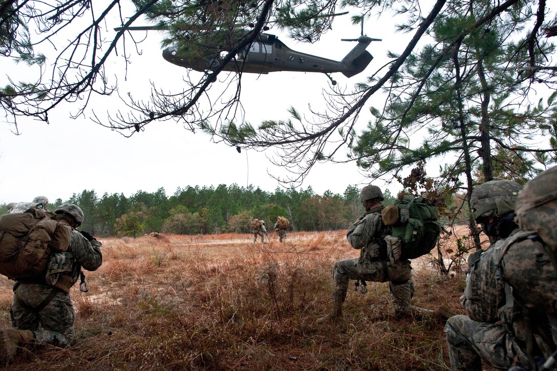 A UH-60 Black Hawk helicopter approaches the extraction point to pick up soldiers via a special patrol insertion/extraction system during phase two of Reconnaissance Surveillance Leaders Course on Fort Benning, Ga,, Nov. 17, 2013.