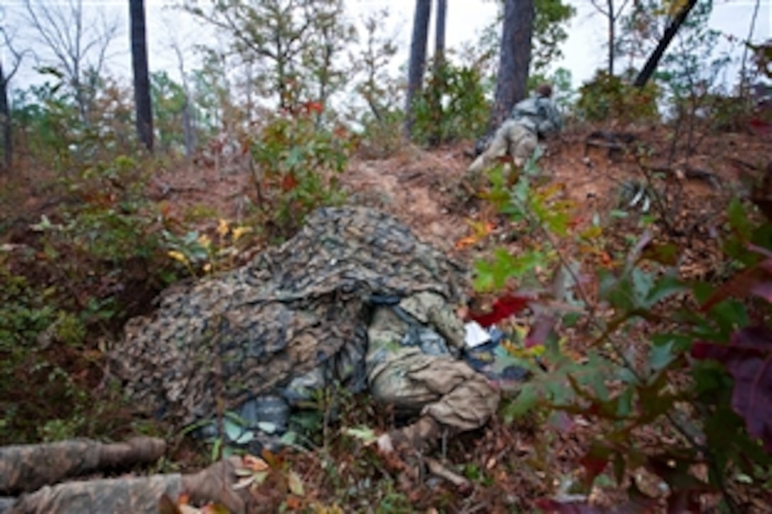 Soldiers man and secure a surveillance site during phase two of the Reconnaissance Surveillance Leaders Course on Fort Benning, Ga., Nov. 15, 2013.