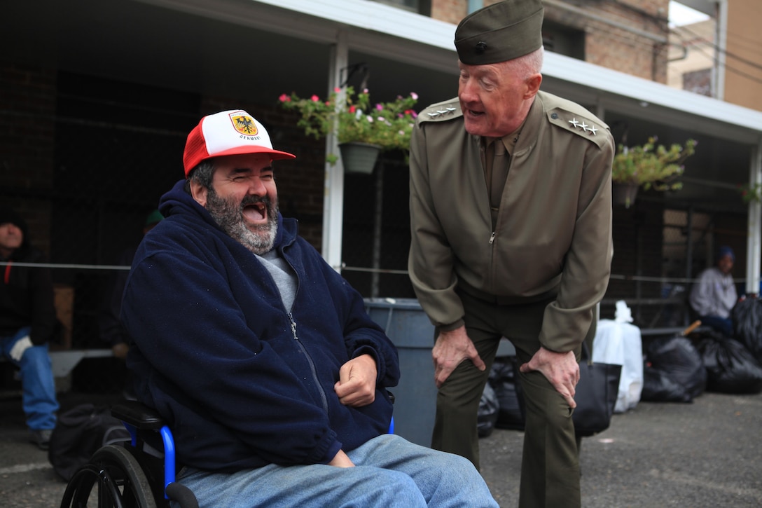 Lt. Gen. Richard P. Mills, commander of Marine Forces Reserve and Marine Forces North speaks to one of the Ozanam Inn homeless shelter volunteers during a cook-out for New Orleans’ homeless, Nov. 25. Mills, along with his wife, Patricia, and Sgt. Maj. Anthony A. Spadaro, senior enlisted advisor for MARFORRES and MARFORNORTH, made an appearance at the shelter to support the volunteer effort to serve 400 of the city’s homeless population. (U.S. Marine Corps Photo by Lance. Cpl. Tiffany Edwards)