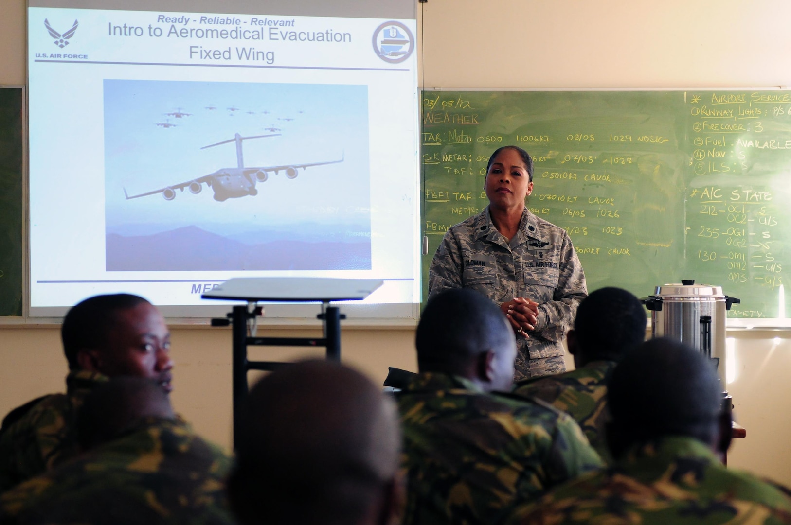 Air National Guard Lt. Col. June Oldman speaks to members of the Botswana defense force prior to classroom instruction at Thebephatswa Air Base, Botswana, for the start of MEDLITE 12, Aug. 6, 2012. MEDLITE 12 is a joint exercise between U.S. and Botswana aimed to establish and develop military interoperability, regional partnership and to synchronize capacity-building. Oldman is the MEDLITE 12 mission director.