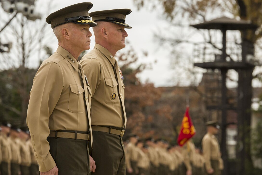 Gen. James F. Amos, commandant of the Marine Corps, left, and Col. Christian G. Cabaniss, Marine Barracks Washington, D.C. commanding officer, stand in front of the battalion during a Navy Meritorious Unit Commendation presentation at the Barracks Nov. 22. The Barracks earned the award for its performance while in support of multiple major events around the national capital region. 