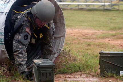 Army Sgt. Matthew Howard, an artillery crew member with Battery C, 2nd Battalion, 142nd Fires Brigade, Arkansas Army National Guard, exits a low-crawl tube, one of the obstacles during the stress shoot event, at Fort Benning, Ga. July 31, 2012 - during the Army National Guard's 2012 Best Warrior Competition. Howard would go on to be named the top noncommissioned officer for the competition, earning a spot to compete at the Department of the Army competition later this year.