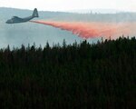 An aircrew from the Wyoming Air National Guard's 153rd Airlift Wing drop fire retardant from a C130-H Hercules aircraft equipped with Modular Airborne Firefighting Systems while assisting with suppression of the Squirrel Creek wildfire about 70 miles east of Cheyenne, Wyo., July 6. In response to increased fire activity in the western United States aircrews from the 153rd Airlift Wing operating MAFFS-equipped C-130s are set to resume operations Tuesday.