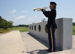 Sgt. Jennifer Bowling, a trumpet and bugle player with the Kentucky Army National Guard's 202nd Army Band plays taps during a ceremony at Fort Eustis, Va. Members of the band recently spent time at Fort Eustis backfilling for members of the Training and Doctrine Command Band who were on block leave.