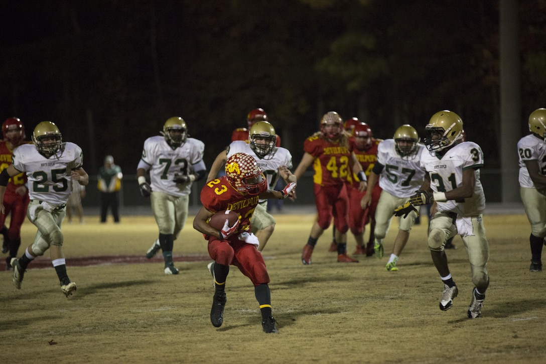 Jamaz Richardson, Lejeune Bulldog starting running back, evades a defender at the second round of the North Carolina High School Athletic Association playoffs aboard Marine Corps Base Camp Lejeune, Nov. 22. This game marked Richardson’s second season in a row recording more than 2,000 rushing yards.