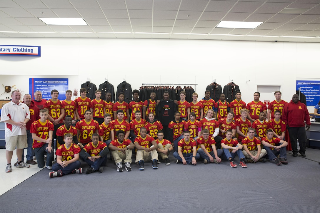 Herschel Walker, retired National Football League player and mixed martial artist, poses with the Camp Lejeune High School football team at the main exchange aboard Marine Corps Base Camp Lejeune, Nov. 25.