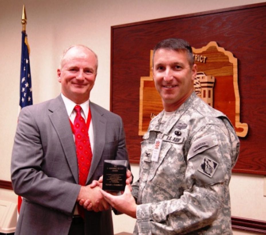 Tulsa District Deputy District Counsel Ron Goodeyon accepts the 2013 E. Manning Seltzer Award from District Commander Col. Richard Pratt. The award is for special contributions to the Corps legal services mission.                  