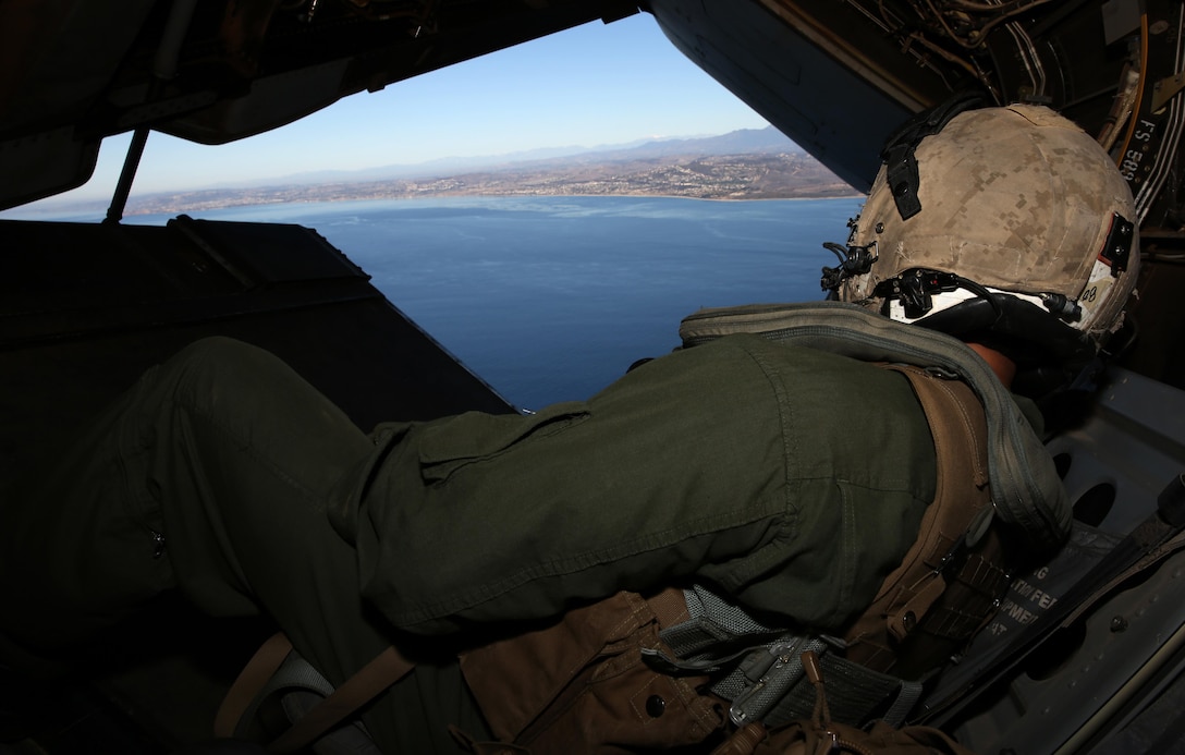 Staff Sgt. Saul Moreno, crew chief with Marine Medium Tiltrotor Squadron 161 (VMM-161) “Greyhawks” and a Fort Worth, Texas, native, watches the skies while banking during tactical-formation training over the Pacific Ocean near San Diego, Nov. 25. During the training, pilots made sharp turns and changed altitude quickly, much like they would in combat while deployed.


