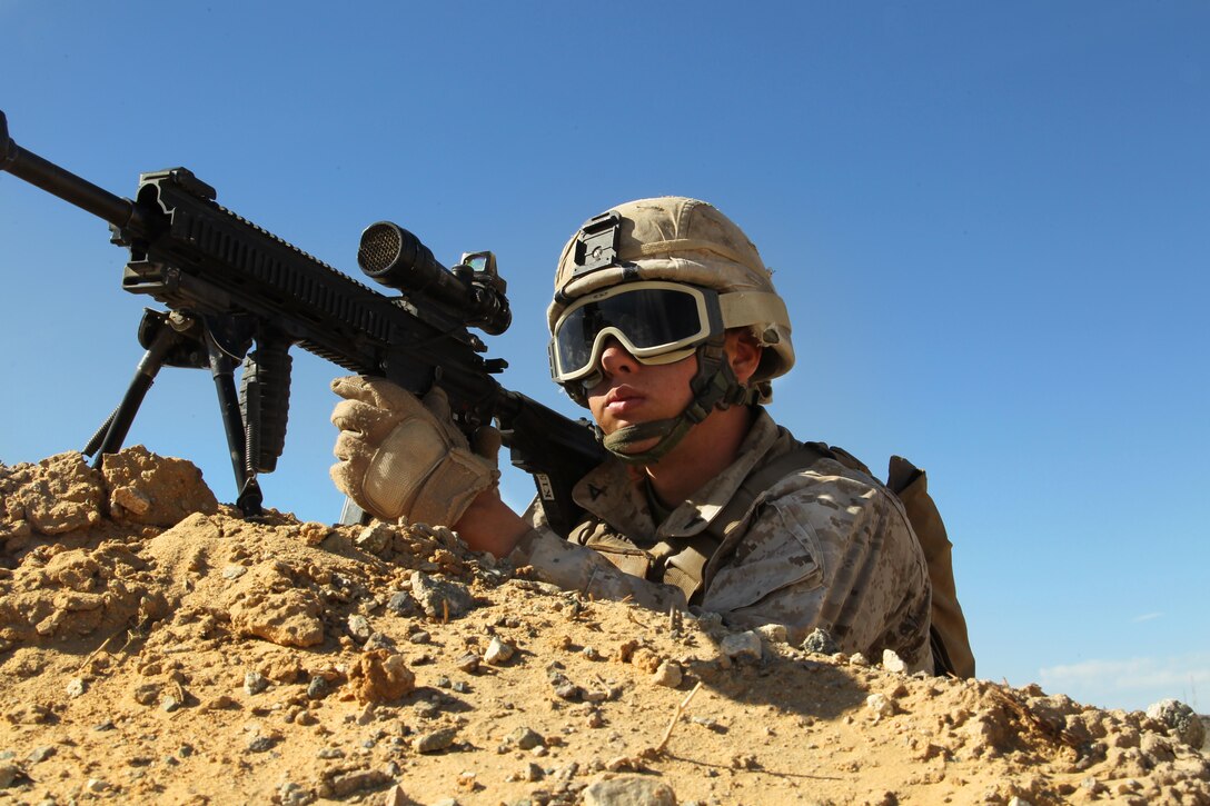 A Marine with Company K, 3rd Battalion, 5th Marine Regiment, posts security near the entrance of a training town in the Combat Center’s Range 215 during a counter insurgency exercise Nov. 18, 2013.
