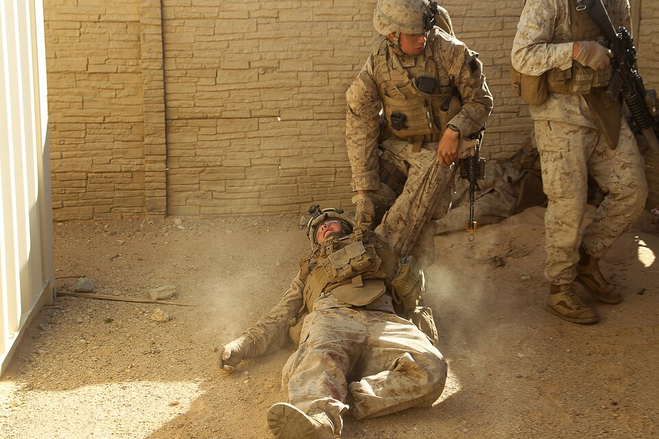 A Navy corpsman drags a Marine who sustained a simulated injury to safety to provide first-aid during a counter insurgency exercise at the Combat Center’s Range 215, Nov. 18th, 2013.