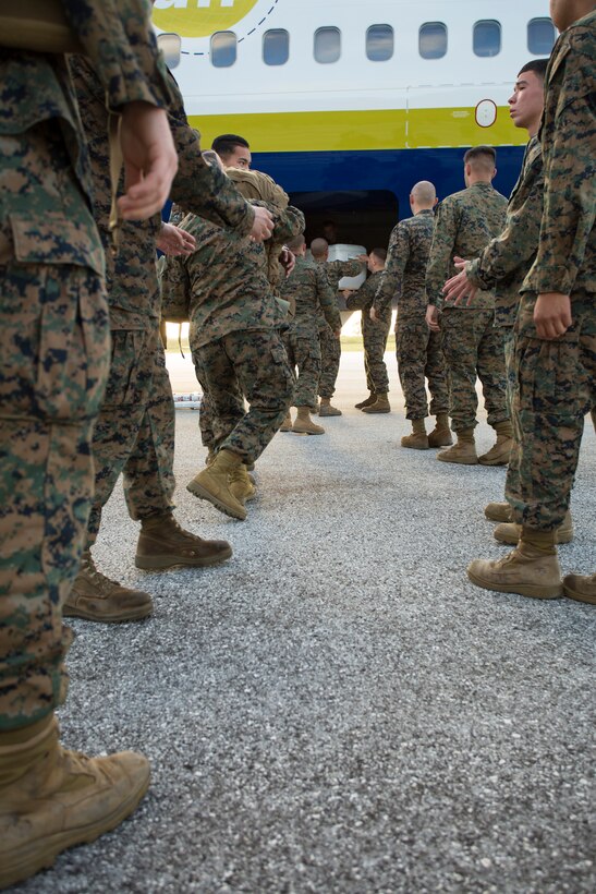U.S. Marines unload their gear from a Boeing 737 at Tinian’s international airport Nov. 6, 2013, as part of the beginning of exercise Forager Fury II. Airmen from the 734th Air Mobility Squadron on Andersen Air Force Base, Guam, supported the Marines by facilitating an estimate of 1,200 passenger movements and loading 200 pallets during the exercise. (U.S. Marine Corps photo by Lance Cpl. Antonio Rubio/Released)