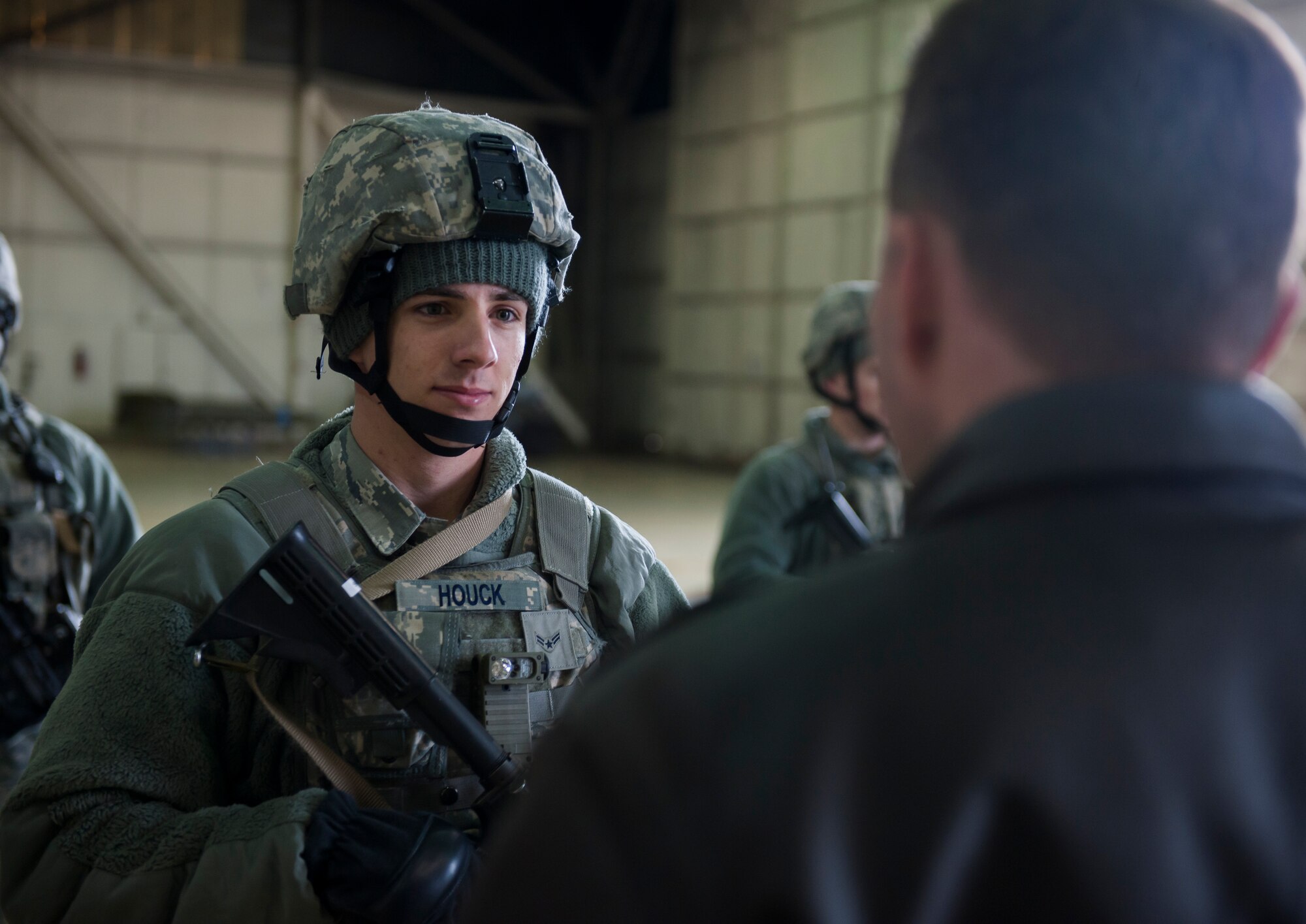 Airman 1st Class Garrett Houck, 8th Security Forces Squadron, listens to Acting Secretary of the Air Force Eric K. Fanning after a security demonstration at Kunsan Air Base, Republic of Korea, Nov. 26, 2013. The secretary visited the Wolf Pack to get a better look at Kunsan’s mission of defending the base, accepting follow-on forces and taking the fight North. (U.S. Air Force photo by Senior Airman Armando A. Schwier-Morales/Released)