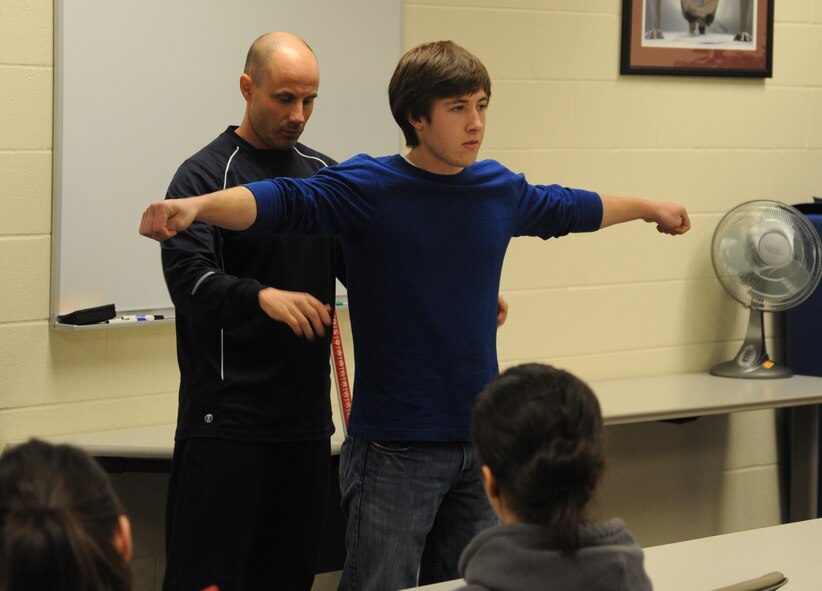 Will Saultes, 92nd Aerospace Medicine Squadron exercise physiologist, evaluates a West Valley High School student’s posture at the Health and Wellness Center at Fairchild Air Force Base, Wash., Nov. 22, 2013.  The stop at the HAWC was part of the wider base tour.  (U.S. Air Force photo by Airman 1st Class Sam Fogleman/Released)