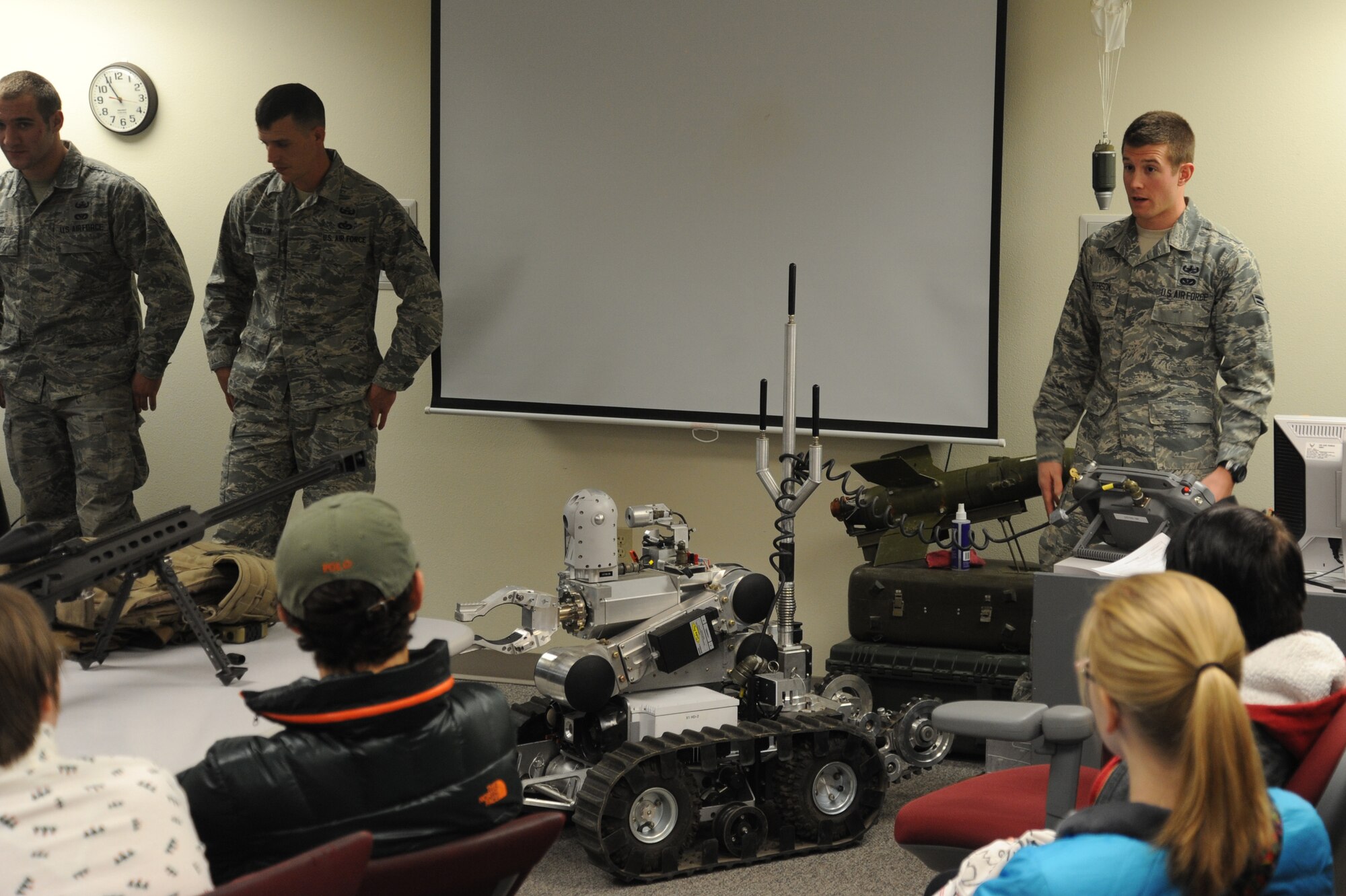 Airman 1st Class Luke Peterson, 92nd Civil Engineer Squadron explosive ordnance disposal technician, talks to West Valley High School students about the F6A explosive ordnance robot at Fairchild Air Force Base, Wash., Nov. 22, 2013.  The high school students toured the base to broaden their understanding of the Spokane community.  (U.S. Air Force photo by Airman 1st Class Sam Fogleman/Released)