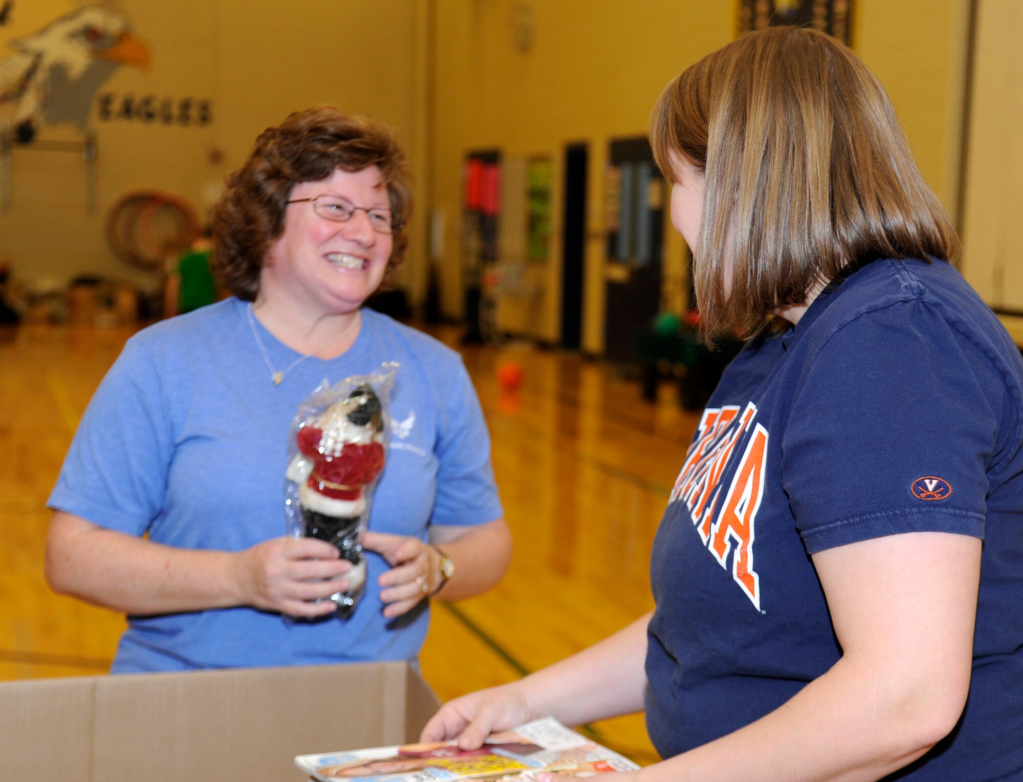 Jill Newberry and Catherine Messer, pack donations for the Treats 2 Troops program at Fairchild Air Force Base, Wash., Nov. 26, 2013. The donations are donated for Treats 2 Troops, a program held by local news station KREM 2. Treats 2 Troops provides deployed Airmen care packages during the Holiday Season. (U.S. Air Force photo by Airman 1st Class Ryan Zeski/Released)