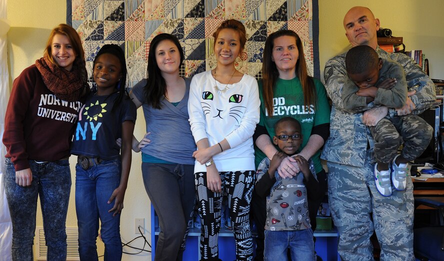 The Massad family poses for a photo in their home at Fairchild Air Force Base, Wash., Nov. 22, 2013. Master Sgt. John Massad and his wife, Dolly, have a total of seven children; five of which are adopted and two are foreign exchange students. (U.S. Air Force photo by Airman 1st Class Janelle Patiño/Released)