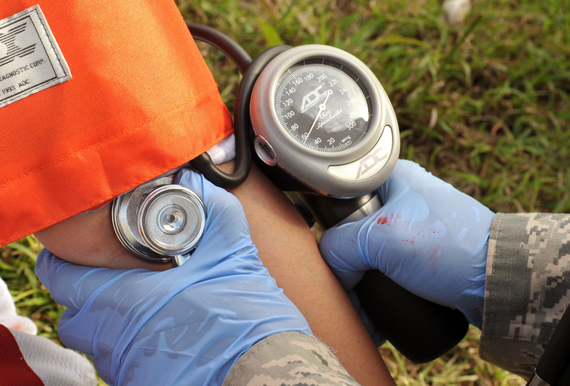 U.S. Air Force Tech. Sgt. Sabrina Torries, 18th Medical Operations Squadron medical technician, checks a simulated patient’s blood pressure during the emergency management exercise at Marek Park on Kadena Air Base, Japan, Nov. 21, 2013. The exercise gave Airmen an opportunity to practice their readiness skills and prepare for real world contingencies in a controlled environment. (U.S. Air Force photo by Naoto Anazawa)