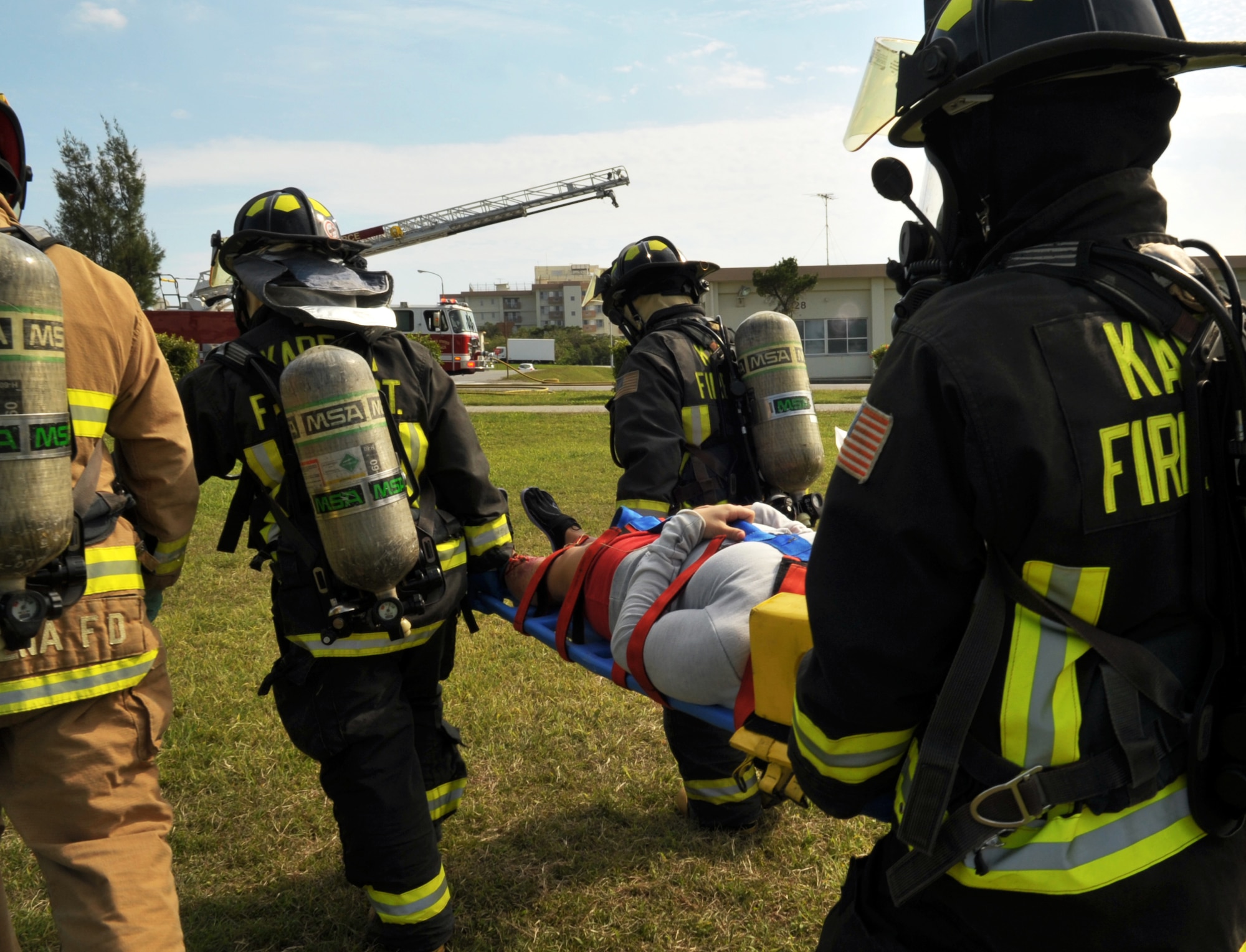 Kadena firefighters transport a simulated patient to a safe area during the emergency management exercise at Marek Park on Kadena Air Base, Japan, Nov. 21, 2013. The exercise was designed to test, train and evaluate the base's ability to respond to crisis situations in the region. (U.S. Air Force photo by Naoto Anazawa)