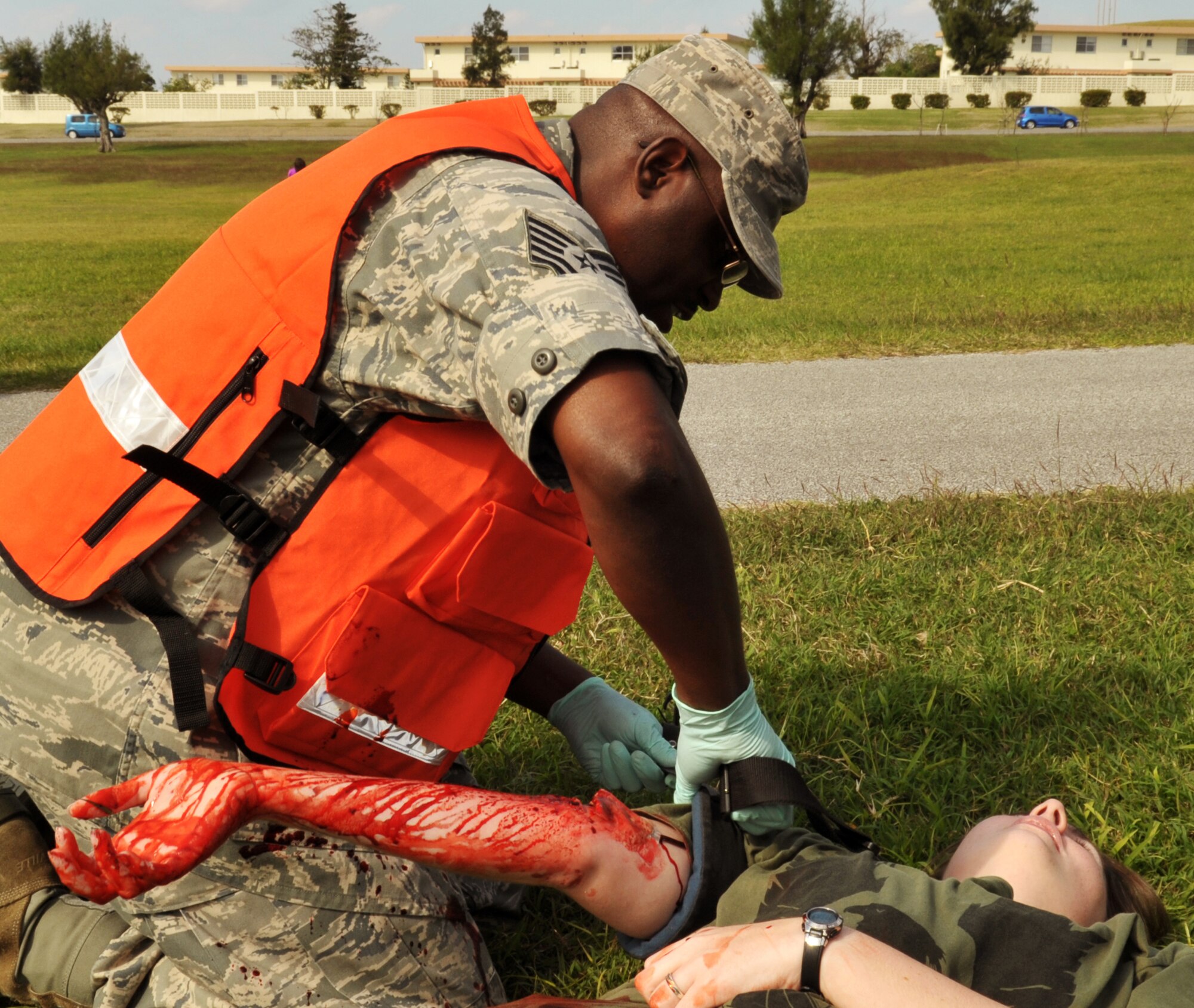 U.S. Air Force Tech. Sgt. Gregory Braker, 18th Aerospace Medicine Squadron assistant NCO in charge, treats a simulated patient during the emergency management exercise at Marek Park on Kadena Air Base, Japan, Nov. 21, 2013. The exercise allowed Airmen to hone their capabilities in case of a real-world crisis situation in their region. (U.S. Air Force photo by Naoto Anazawa)