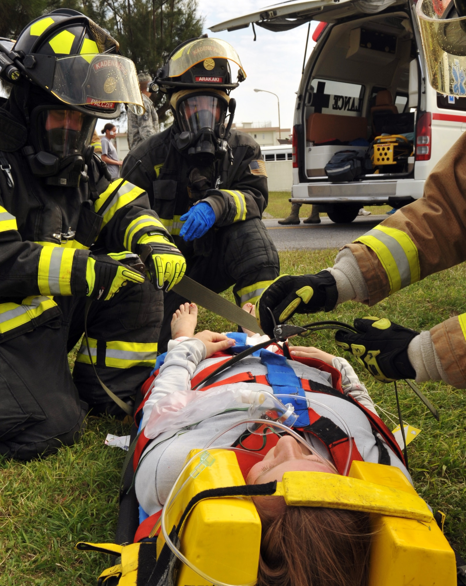 Kadena firefighters tighten a simulated patient’s litter straps before putting her into an ambulance for transportation to the hospital during an emergency management exercise at Marek Park on Kadena Air Base, Japan, Nov. 21, 2013. The exercise was designed to test Kadena's Airmen on their ability to survive and operate in a multitude of scenarios in order to prepare them for real world contingencies. (U.S. Air Force photo by Naoto Anazawa)