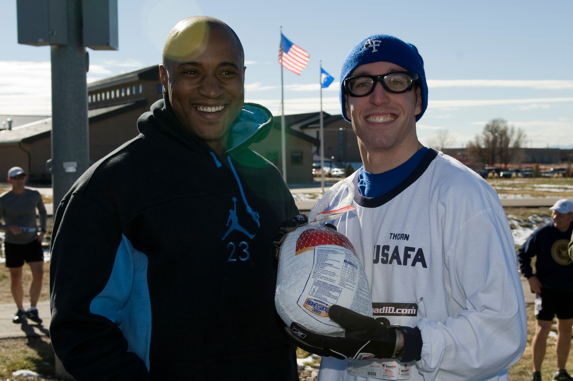 Brian Thorn, 460th Space Communications Squadron network communications officer in charge, receives a turkey at the 9th Annual Turkey Trot 5K race Nov. 26, 2013, at the all-purpose field on Buckley Air Force Base, Colo. Thorn received a turkey for being the overall winner with a time of 19:49. (U.S. Air Force photo by Senior Airman Phillip Houk/Released)