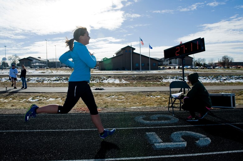 Mary Alder, Aerospace Data Facility - Colorado contractor, finishes the 9th Annual Turkey Trot 5K race Nov. 26, 2013, at the all-purpose field on Buckley Air Force Base, Colo. Alder was 1 of 19 Team Buckley competitors. The fastest runners in each category were given turkeys as prizes. (U.S. Air Force photo by Senior Airman Phillip Houk/Released)