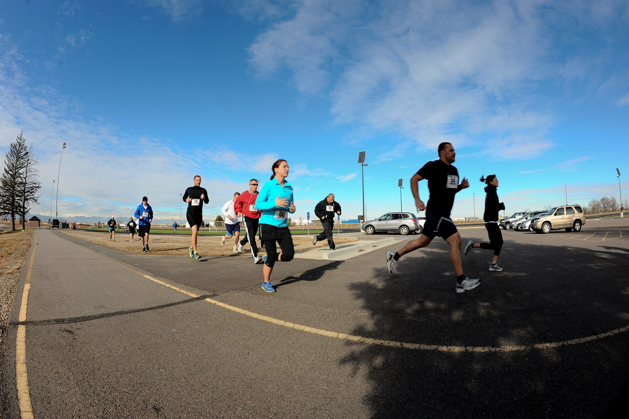 Members of Team Buckley begin the 9th Annual Turkey Trot 5K race Nov. 26, 2013, at the all-purpose field on Buckley Air Force Base, Colo. The fastest runners in each category were given turkeys as prizes. (U.S. Air Force photo by Senior Airman Phillip Houk/Released)