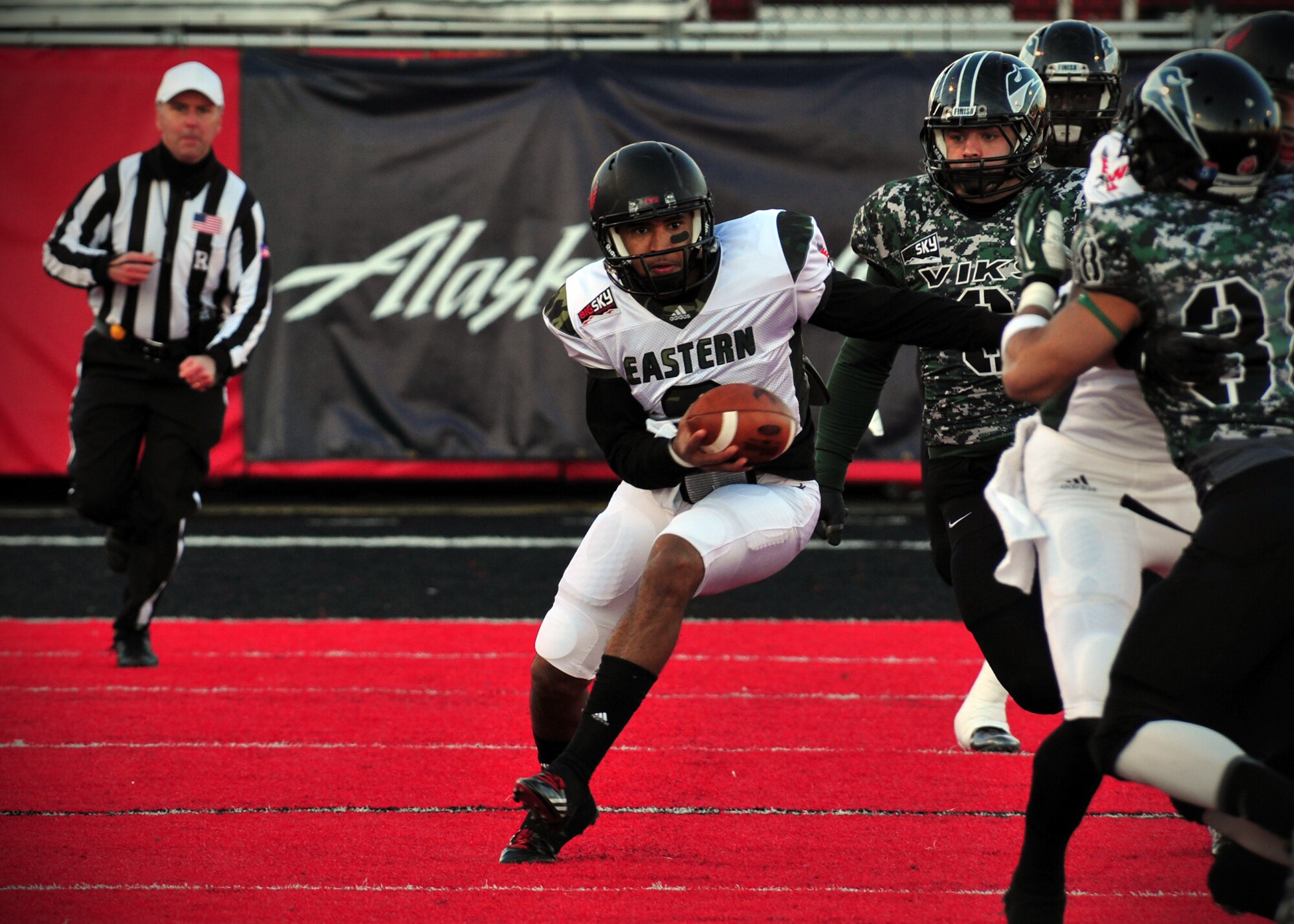 A member of the Eastern Washington University football team runs the ball down the field during the EWU military appreciation game at Roos Field in Cheney, Wash., Nov. 23, 2013. (U.S. Air Force photo by Senior Airman Taylor Curry/Released) 