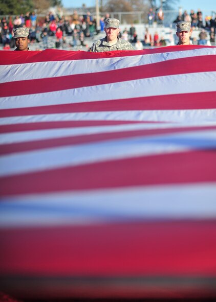 Members of the Eastern Washington University Reserve Officer Training Corp present the U.S. flag during the military appreciation game at Roos Field in Cheney, Wash., Nov. 23, 2013. Military families were given free admission to the game and invited to a BBQ tailgate before the game. (U.S. Air Force photo by Senior Airman Taylor Curry/Released)